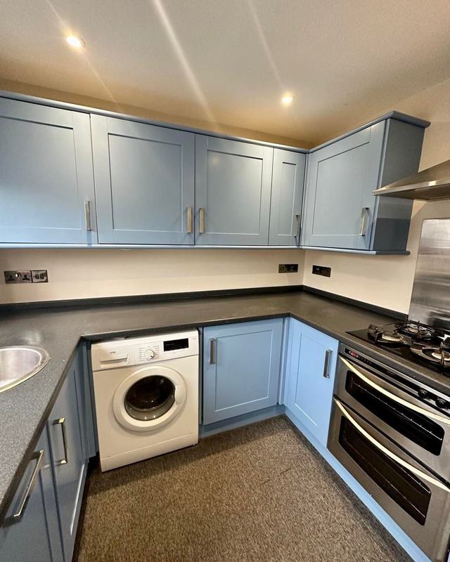 The same kitchen hand painted pale blue-grey
