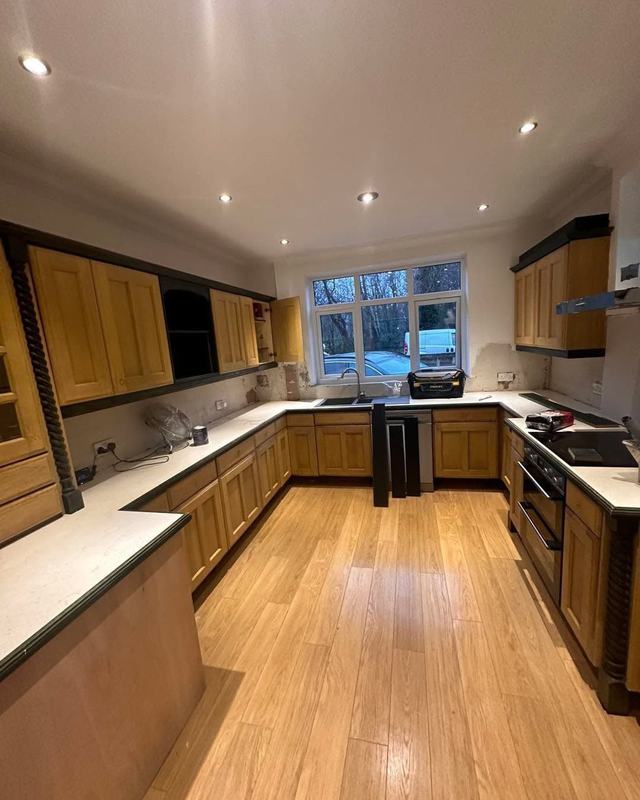 Long kitchen with oak-effect units, before