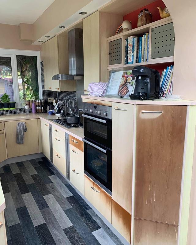 Kitchen with beech units and a striped floor, before