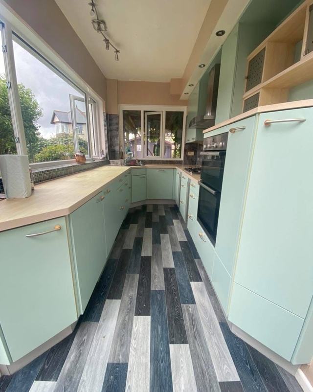 Kitchen hand painted mint green with a striped floor