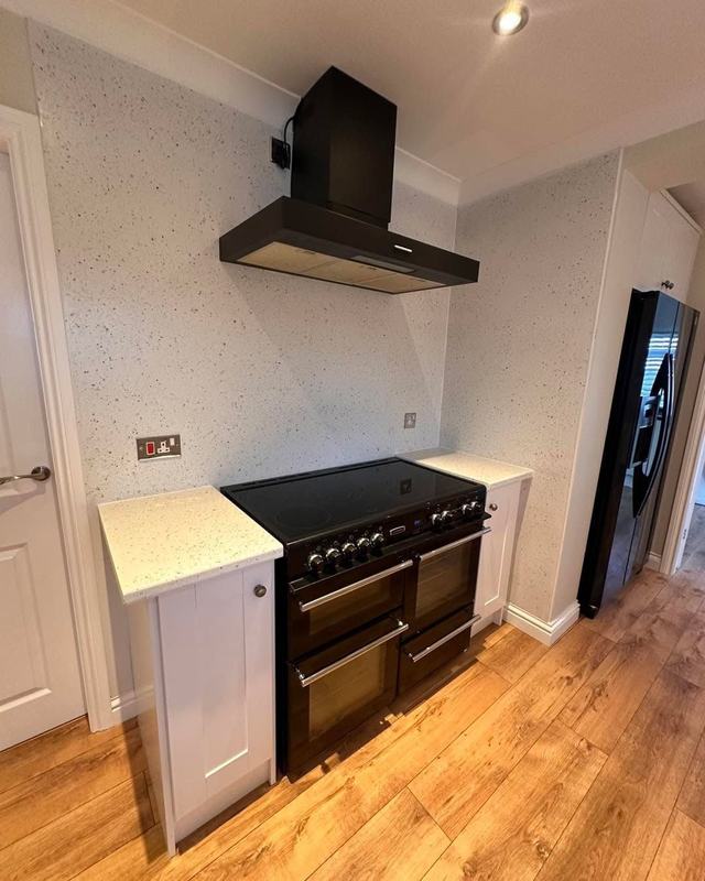 Kitchen with cream painted units and a range cooker