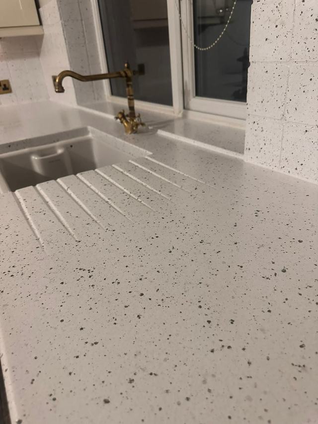 Close-up of a speckled white Spray Granite worktop